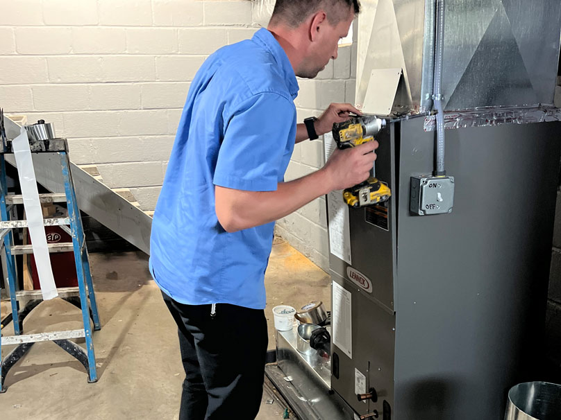 Perfect Air tech servicing a furnace