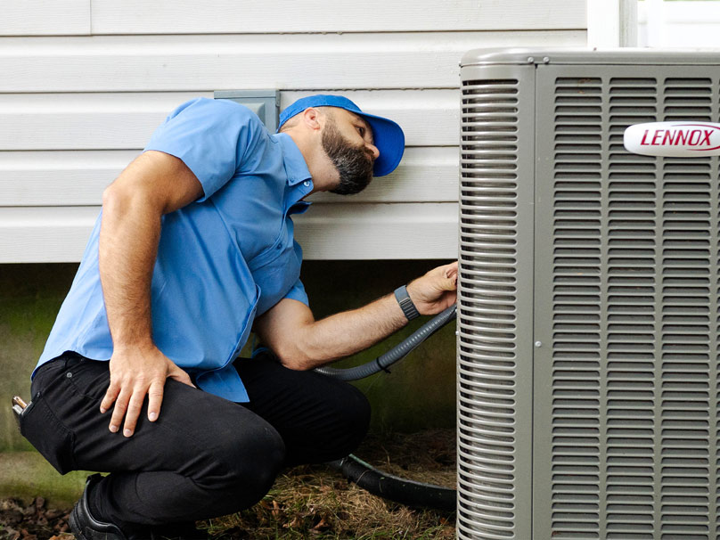 Perfect Air tech servicing a Lennox AC